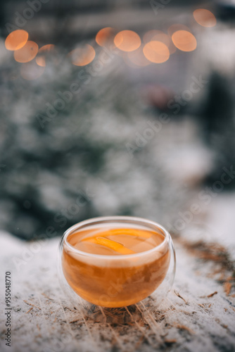 Enjoying warm lemon tea in a cozy winter setting with frosty surroundings and a tranquil atmosphere