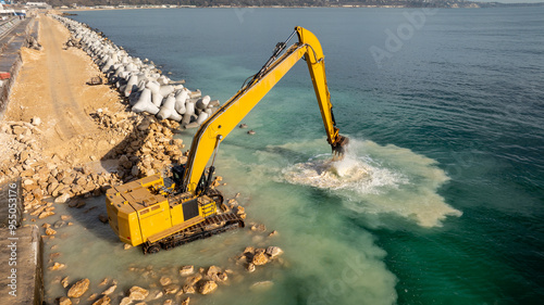 Картината върху платно Waterfront construction site with excavator