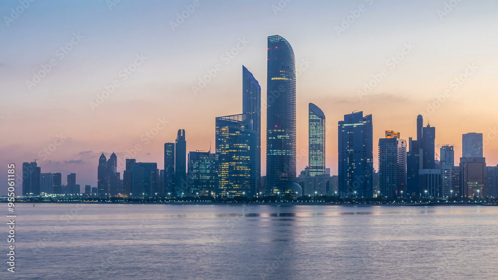 Abu Dhabi city skyline with skyscrapers before sunrise with water reflection night to day timelapse Abu Dhabi city skyline with skyscrapers before sunrise with water reflection night to day timelapse