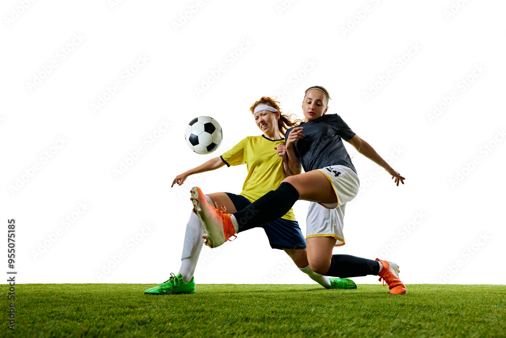 Obraz premium Two young athletic women, soccer players in their 20s, engaged in close tackle on soccer field, both intensely focused on winning ball. Concept of sport, competition, tournament, games, event.