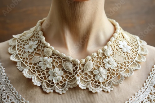 Delicate lace collar adorned with intricate floral patterns and scalloped edges, adding a touch of vintage elegance to a classic garment or accessory.