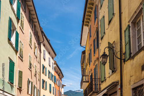 Fototapeta Naklejka Na Ścianę i Meble -  Colorfull buildings in a street of the Riva del Garda, town on the shores of Lake Garda, Italy, Europe.