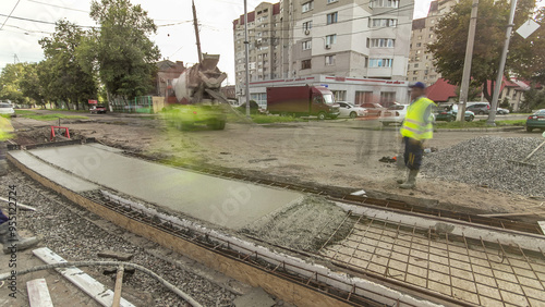 Concrete works for road construction with many workers and mixer timelapse hyperlapse photo