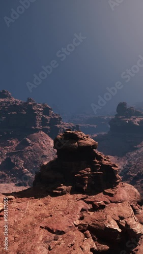 A captivating and majestic red stone canyon rock formation stands tall, amidst a breathtaking backdrop of towering mountains. photo