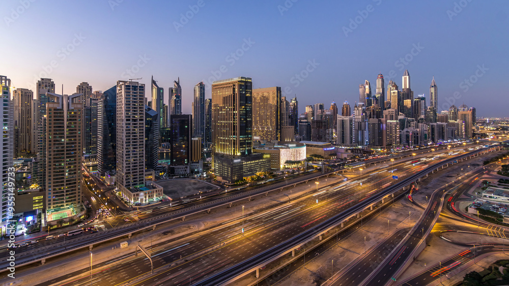 Dubai marina with traffic on sheikh zayed road panorama day to night timelapse lights turn on. Dubai marina with traffic on sheikh zayed road panorama day to night timelapse lights turn on.