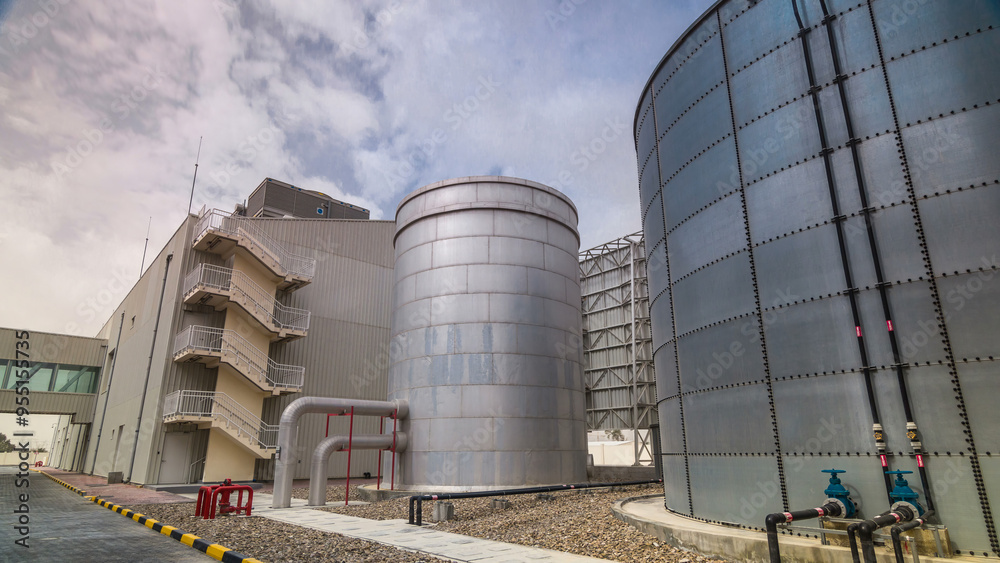 Fototapeta premium Two silver Water Tanks with fence timelapse hyperlapse