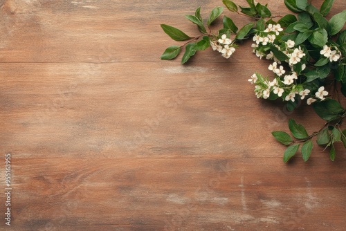 A rustic wooden background adorned with green leaves and small white flowers on the right corner, ideal for nature-themed designs, greeting cards, or seasonal promotions,