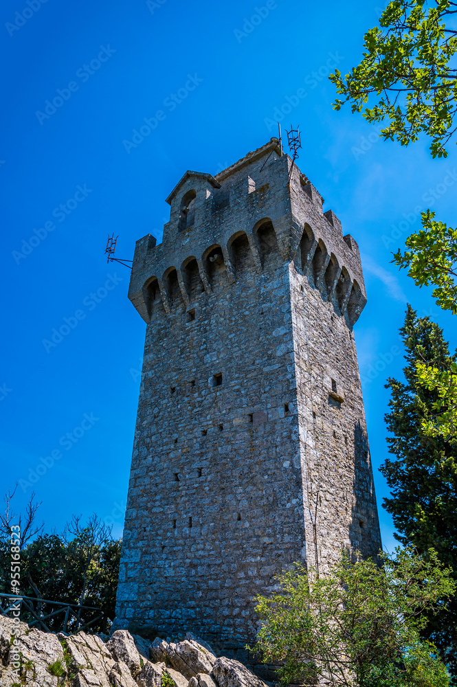 A view looking up towards the third tower in the fortified section of San Marino, Italy in summertime A view looking up towards the third tower in the fortified section of San Marino, Italy in summertime