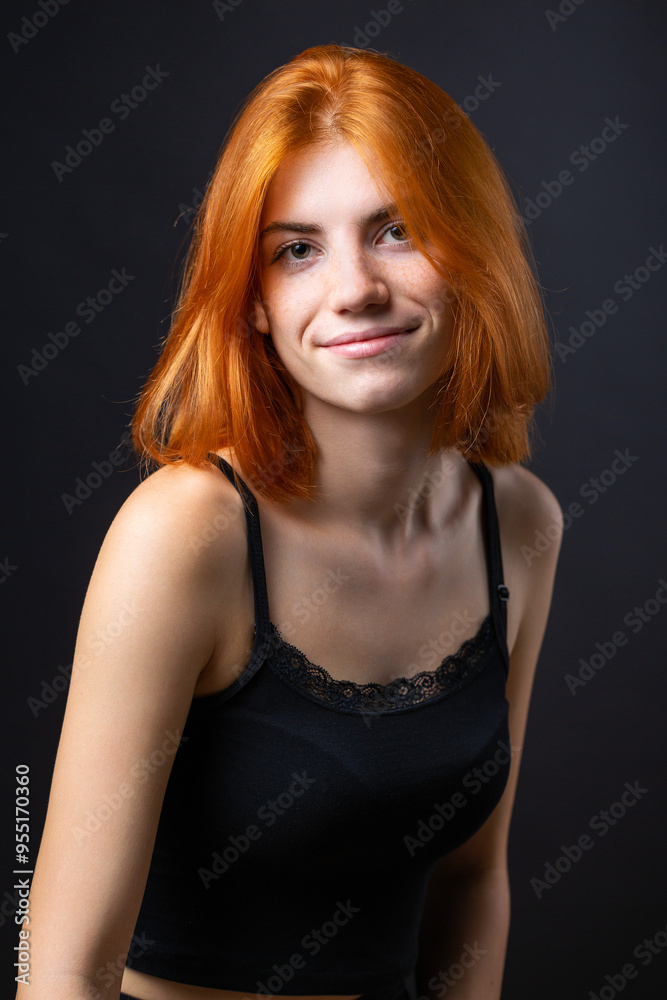 Cute red-haired girl, studio portrait on a black background. Cute red-haired girl, studio portrait on a black background.