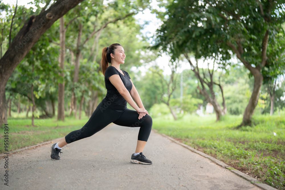 Asian woman stretching to warm up before going for a run in the park. Hair care concept before exercise to reduce injuries. Health care affected by sports. Asian woman stretching to warm up before going for a run in the park. Hair care concept before exercise to reduce injuries. Health care affected by sports.