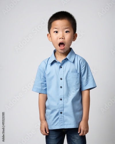  boy in a blue shirt making a surprised face.