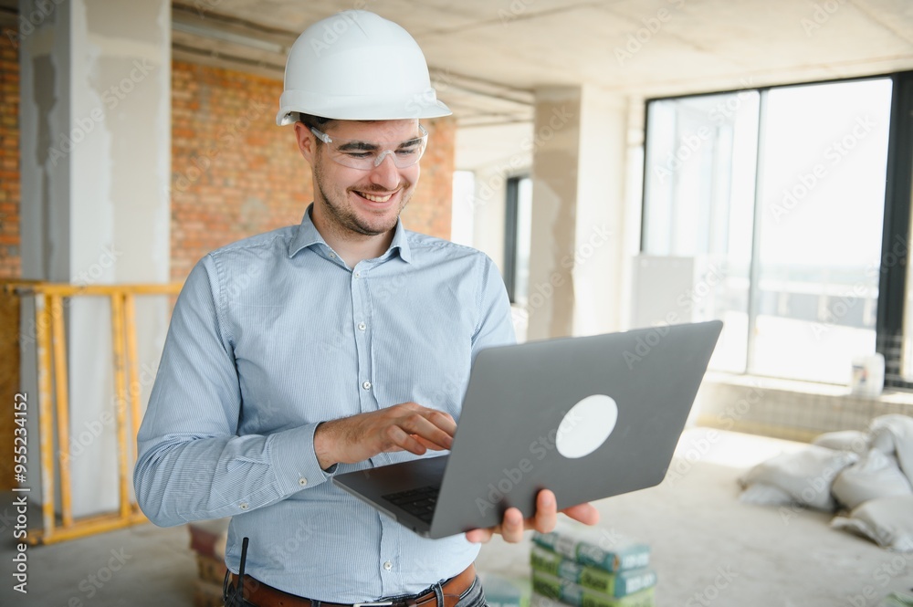 Supervisor using laptop at construction site