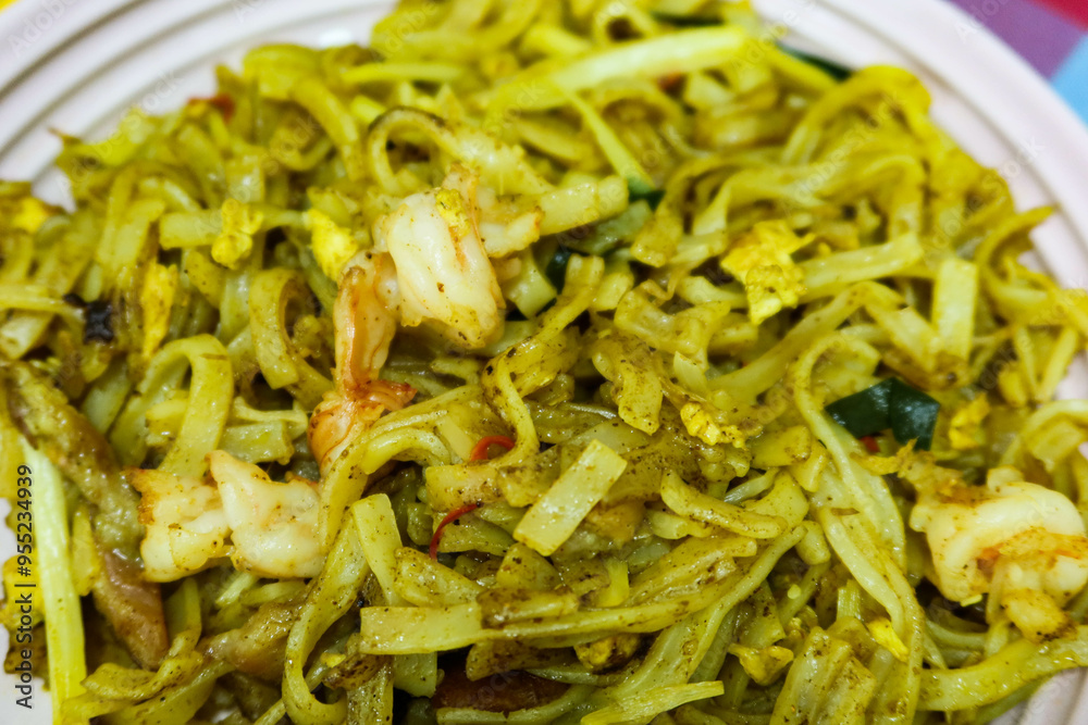 close up of Hong Kong style stir fried Singaporean fried vermicelli noodles with prawns and pork in a pink plate