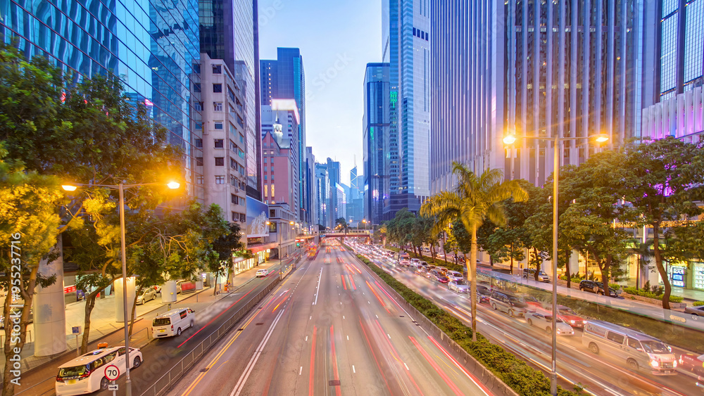 Hong Kong street with busy traffic and skyscraper office at dusk day to night timelapse. Hong Kong street with busy traffic and skyscraper office at dusk day to night timelapse.