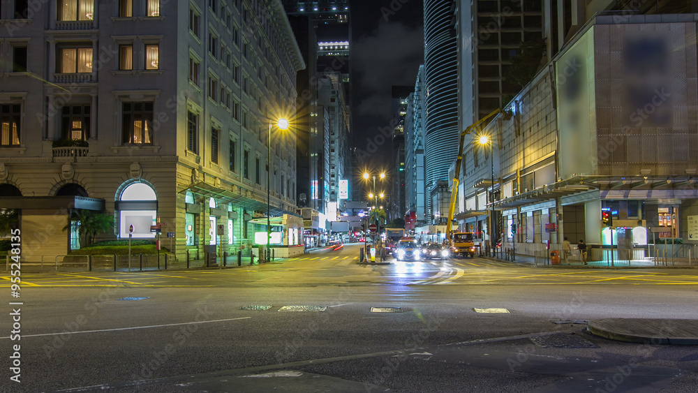Fototapeta premium Neon lights on Tsim Sha Tsui street timelapse hyperlapse with traffic near Pehinsula.