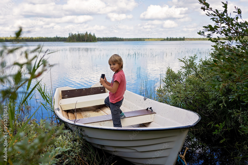 Children, playing on a boat in a river, summertime, watching nature with binoculars, sunny weather Children, playing on a boat in a river, summertime, watching nature with binoculars, sunny weather