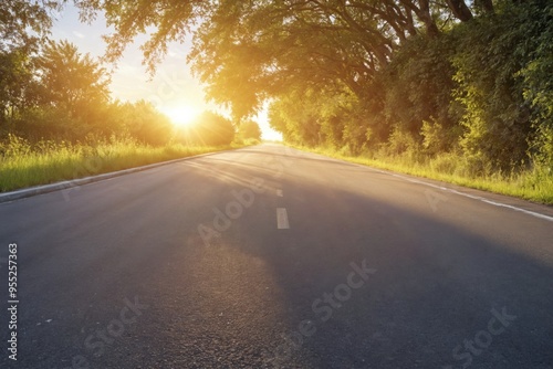 Long straight road that stretches into distance is In the sunset