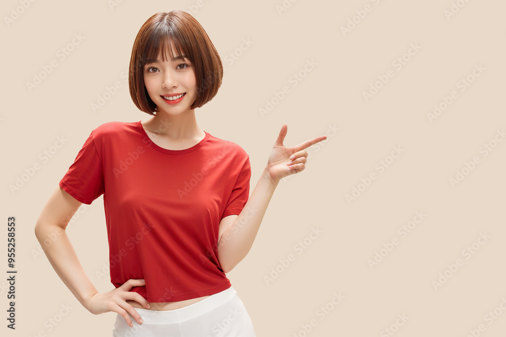 A woman in a red shirt points to the right A woman in a red shirt points to the right