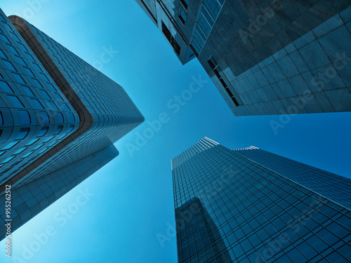 shot between the skyscraper towers racing through the sky with blue sky