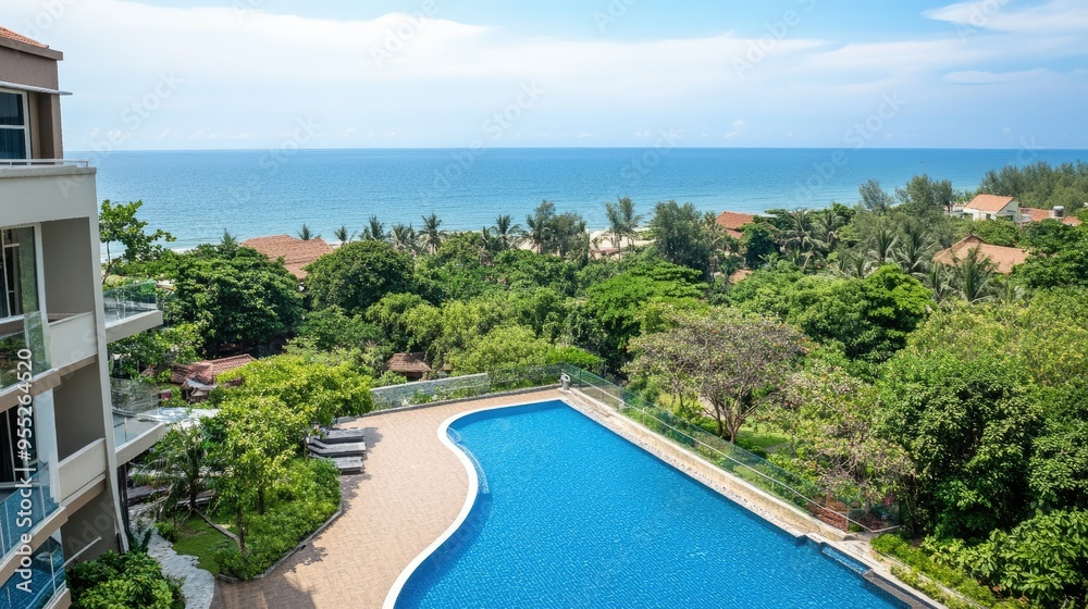 Hua Hin serviced condominium for rent near the beach, offering stunning ocean views, a refreshing swimming pool, and vibrant green trees in a tropical setting Hua Hin serviced condominium for rent near the beach, offering stunning ocean views, a refreshing swimming pool, and vibrant green trees in a tropical setting