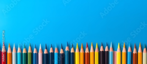 colored pencils on blue background with copy space
