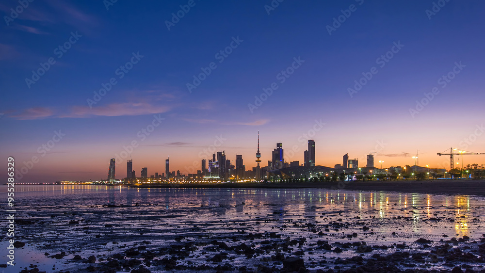 Fototapeta premium Seaside skyline of Kuwait city from night to day timelapse