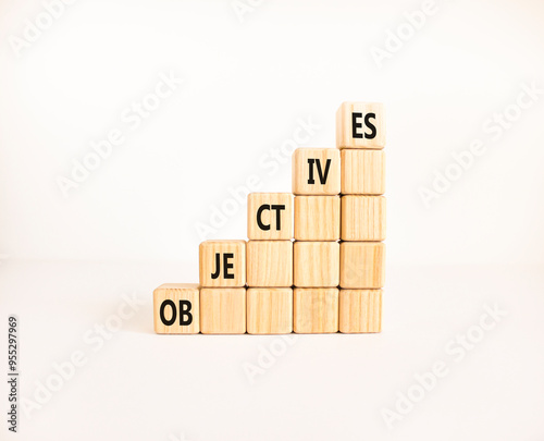 Objectives symbol. Concept word Objectives on beautiful wooden cubes. Beautiful white background. Business objectives concept. Copy space.