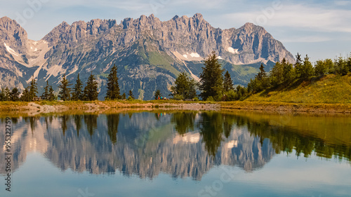 Alpine summer view with reflections and Mount Wilder Kaiser at Mount Astberg, Going, Kitzbuehel, Tyrol, Austria photo