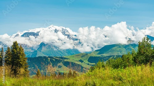 Alpine landscape in France, close to the village of Megeve, with the famous White Mountain, the highest peak in Europe, with white clouds and big glaciers. Blue sky on the background.