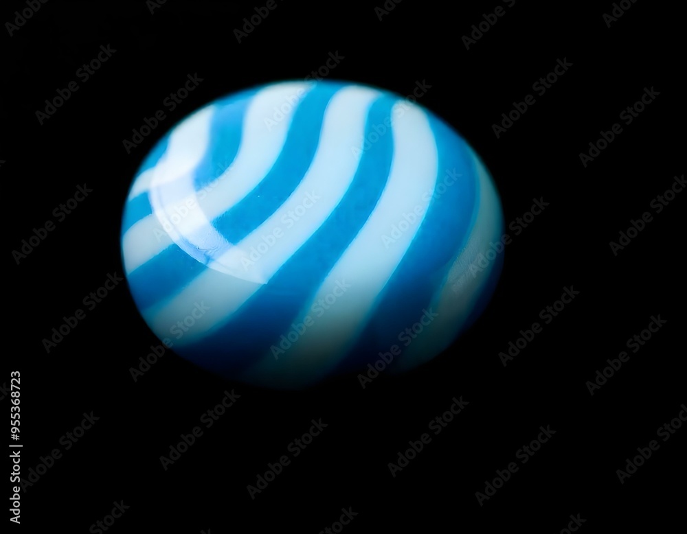 a close-up of a blue and white striped candy resting on a black background, emphasizing its round shape and shine create with ai a close-up of a blue and white striped candy resting on a black background, emphasizing its round shape and shine create with ai