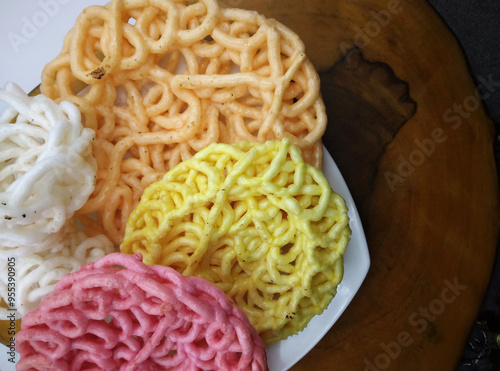 Colorful Indonesian Deep Fried Shrimp and Tapioca Crackers, Kroepoek Kampoeng. Top down view of savory oriental snack photo