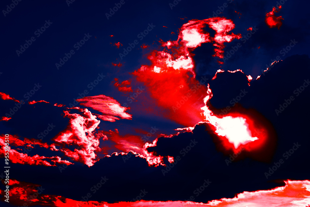 Surreal sky with red clouds. Vibrant red sky filled with fluffy clouds, creating a dramatic and striking atmosphere at dusk. Surreal sky with red clouds