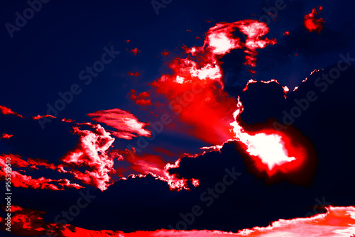 Obraz na płótnie Surreal sky with red clouds. Vibrant red sky filled with fluffy clouds, creating a dramatic and striking atmosphere at dusk. Surreal sky with red clouds w salonie