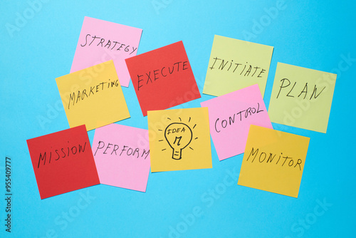 Colorful sticky notes with business concepts displayed on clips for brainstorming sessions