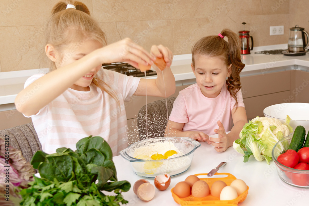 happy family funny kids are preparing the dough, bake cookies in the kitchen. sisters having fun together laughing happy family funny kids are preparing the dough, bake cookies in the kitchen. sisters having fun together laughing