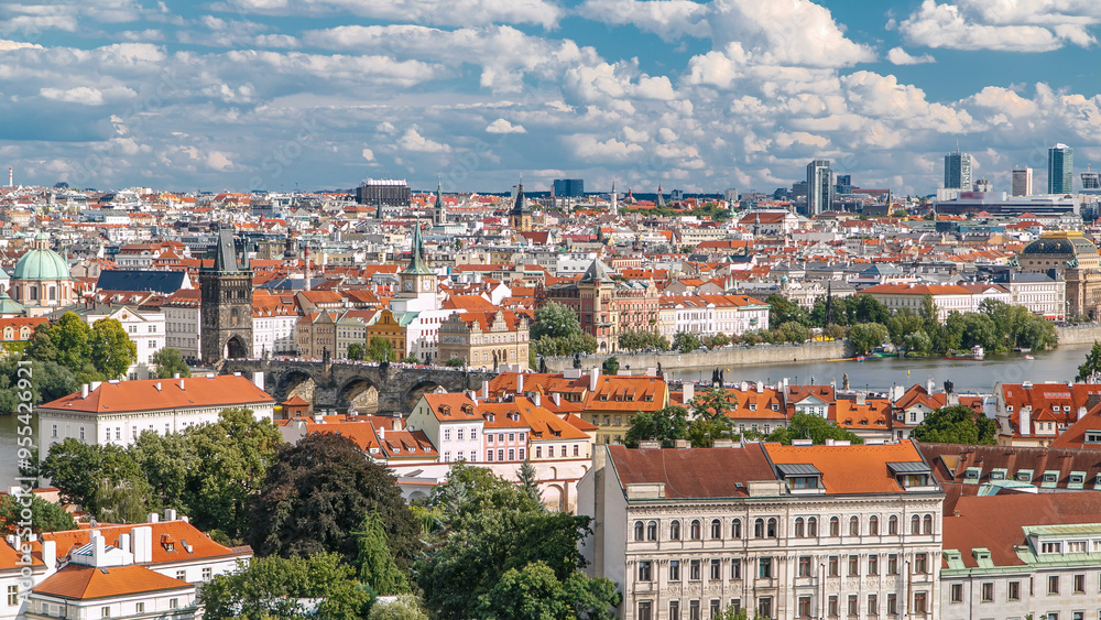 Obraz premium Panorama of Prague Old Town with red roofs timelapse, famous Charles bridge and Vltava river, Czech Republic.