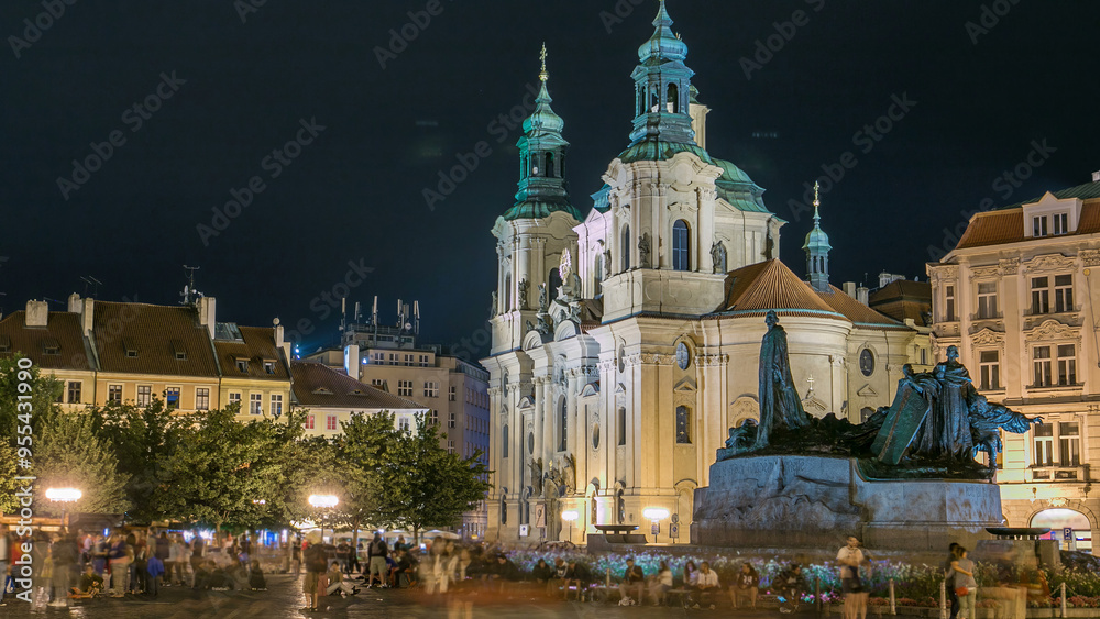 Obraz premium Baroque St. Nicholas' Cathedral on the Oldtown Square in Prague with monument Jan Hus illuminated at night timelapse