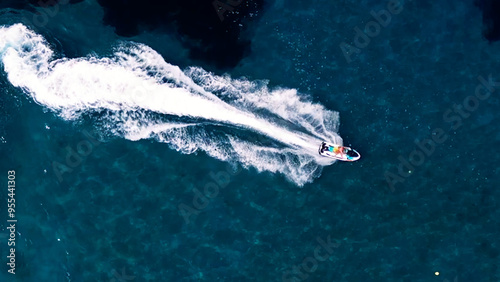 Vertical Aerial View of Deep Blue Sea Water with Yacht and Boat Leaving White Foamy Trail