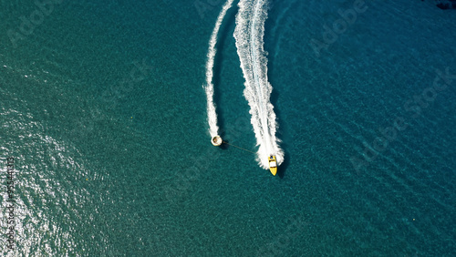 Vertical Aerial View of Deep Blue Sea Water with Yacht and Boat Leaving White Foamy Trail