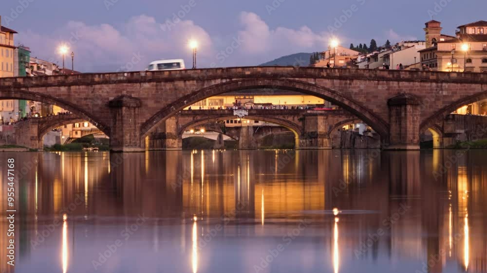 Day to night transition timelapse Ponte alla Carraia, St. Trinity and Ponte Vecchio stone bridges over of Arno river with clear reflections, in Florence, Italy. Day to night transition timelapse Ponte alla Carraia, St. Trinity and Ponte Vecchio stone bridges over of Arno river with clear reflections, in Florence, Italy.