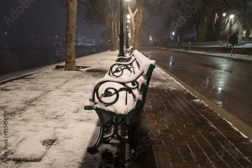 snowy park bench along the street covington kentucky photo