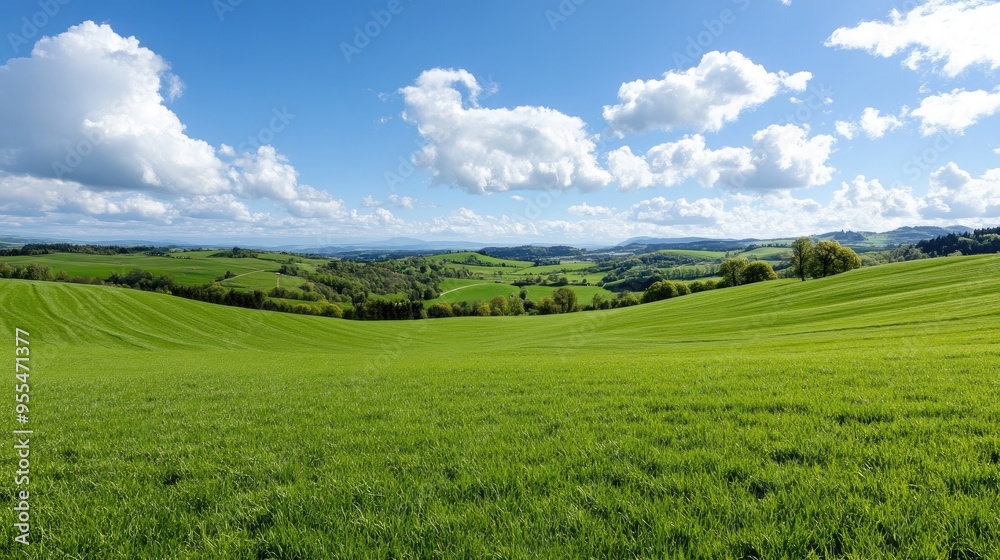 Rolling countryside landscape panorama with green pastures and distant hills Rolling countryside landscape panorama with green pastures and distant hills