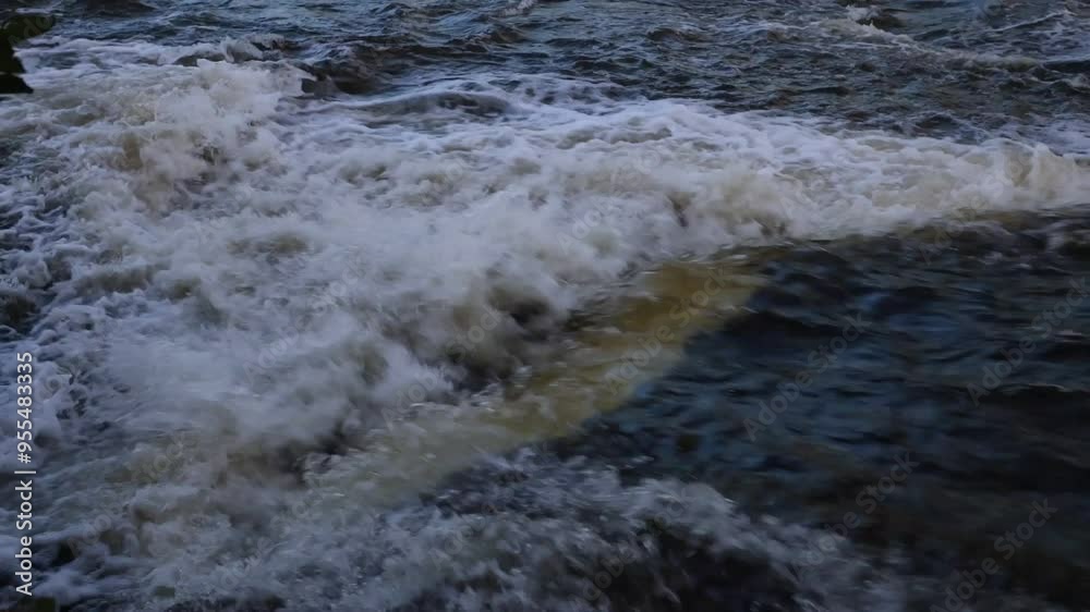 Water flowing over rocks making white foam Water flowing over rocks making white foam