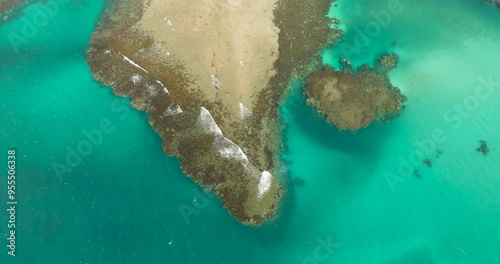 Waves crashing on coral reefs with turquoise water. Sandy seafloor. Mindanao, Philippines. Seascape. photo