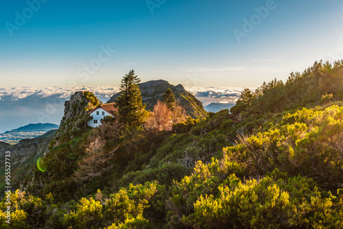 Hiking on the highest peak of Madeira Pico Ruivo next to the cottage Abrigo do Pico Ruivo. Views of the surrounding mountains lanscape during sunny day photo