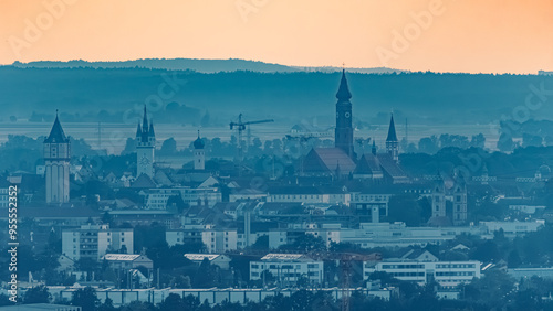 Sunset with a far view of the churches and towers of Straubing center seen from Mount Bogenberg, Bavaria, Germany