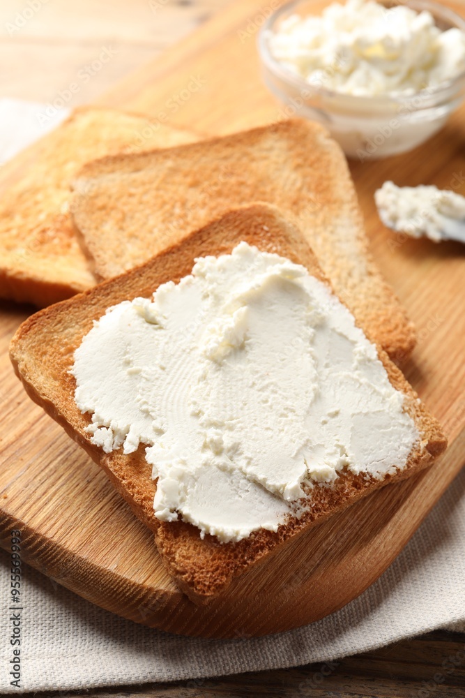 Delicious toasted bread slices with cream cheese on table Delicious toasted bread slices with cream cheese on table