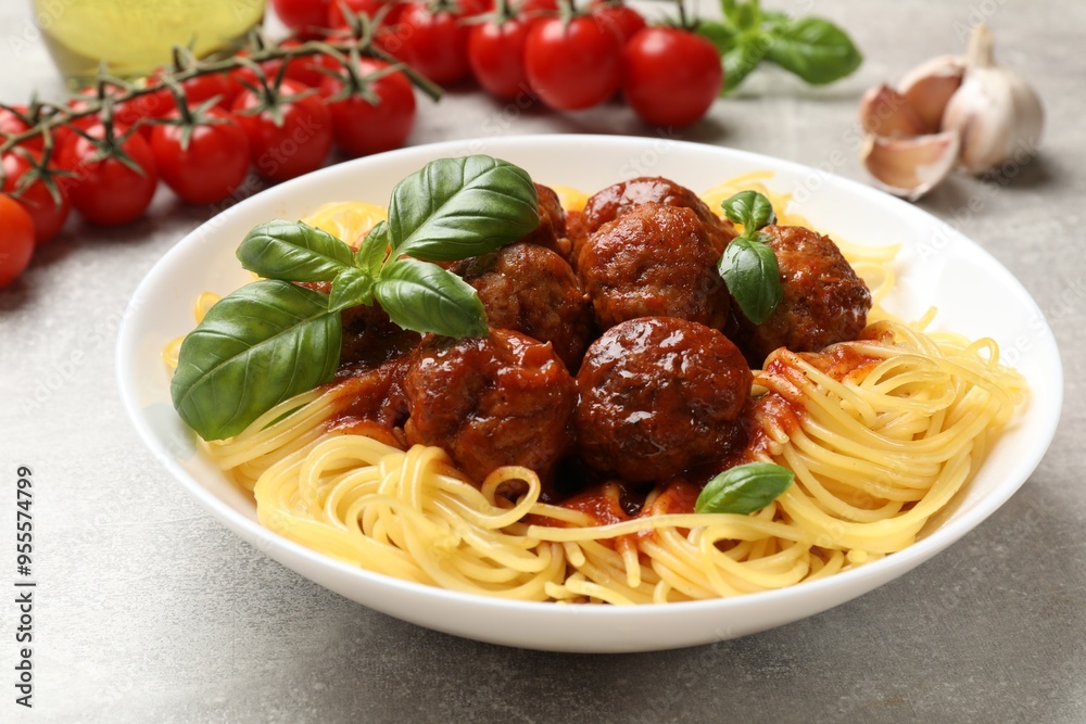 Delicious pasta with meatballs and ingredients on grey table, closeup Delicious pasta with meatballs and ingredients on grey table, closeup