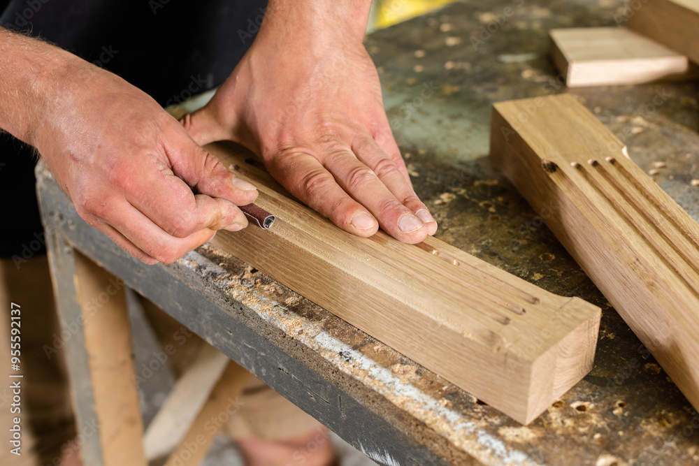 The carpenter manually grinds the milled parts The carpenter manually grinds the milled parts