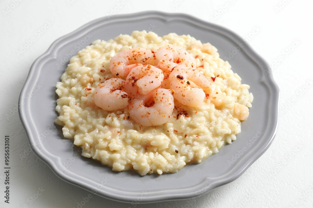 Delicious risotto with shrimps and cheese on white table, closeup Delicious risotto with shrimps and cheese on white table, closeup